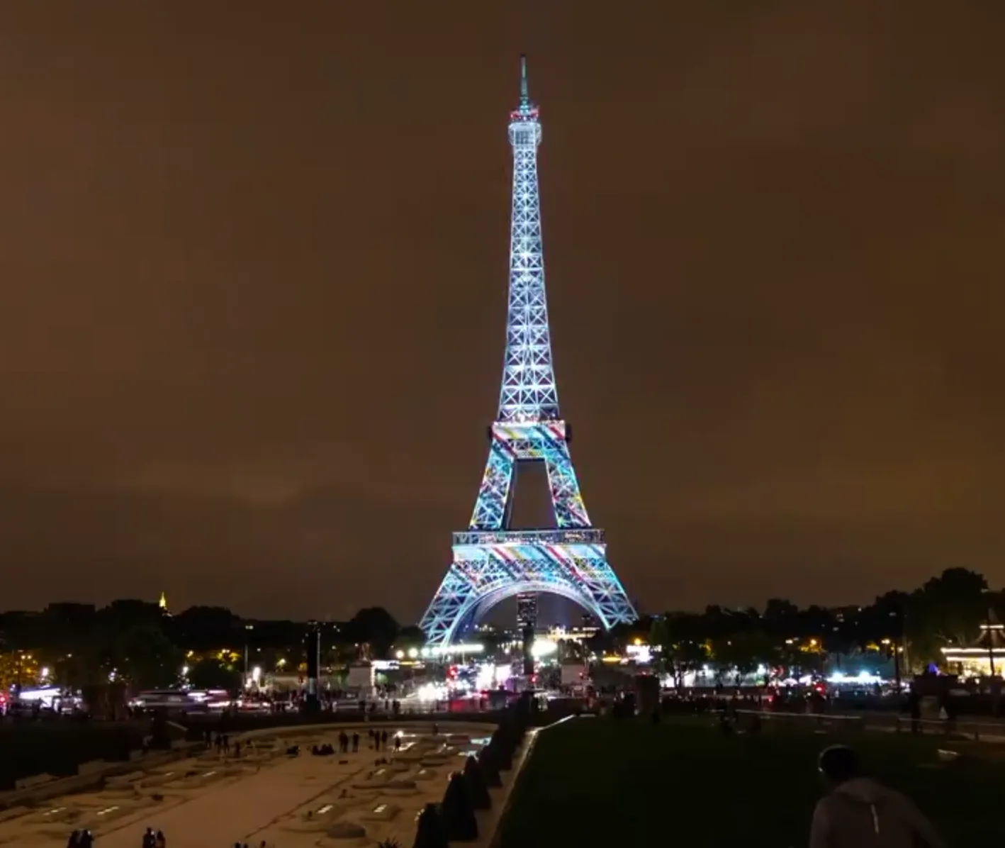 Kimono patterns projected across the Eiffel Tower in white and red.
