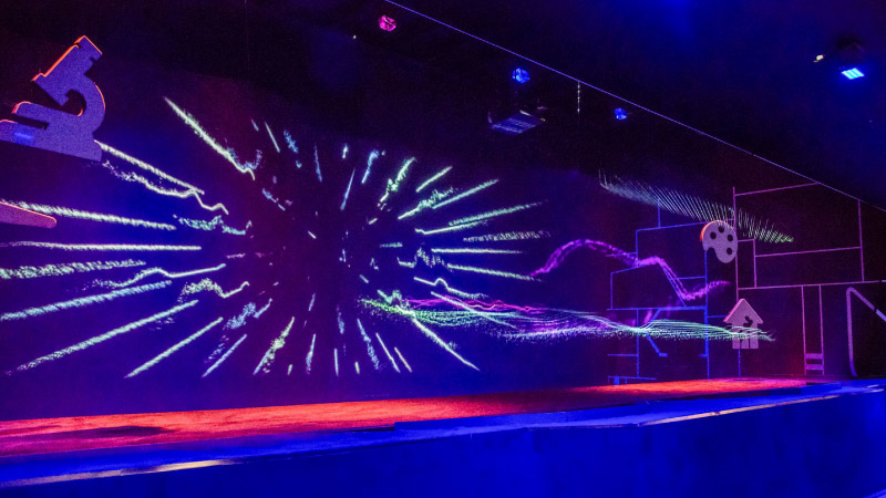 The holographic main show: projected energy bursting across layered screens