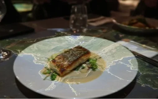 A projection-mapped dining table mid-course.