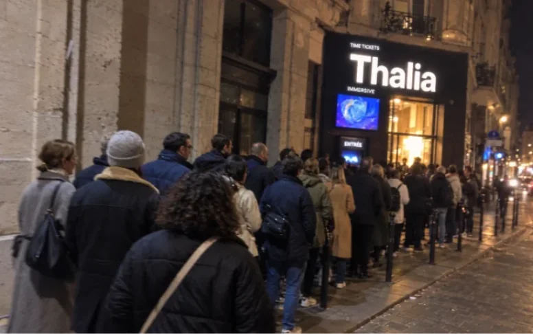 An evening queue outside an immersive venue.