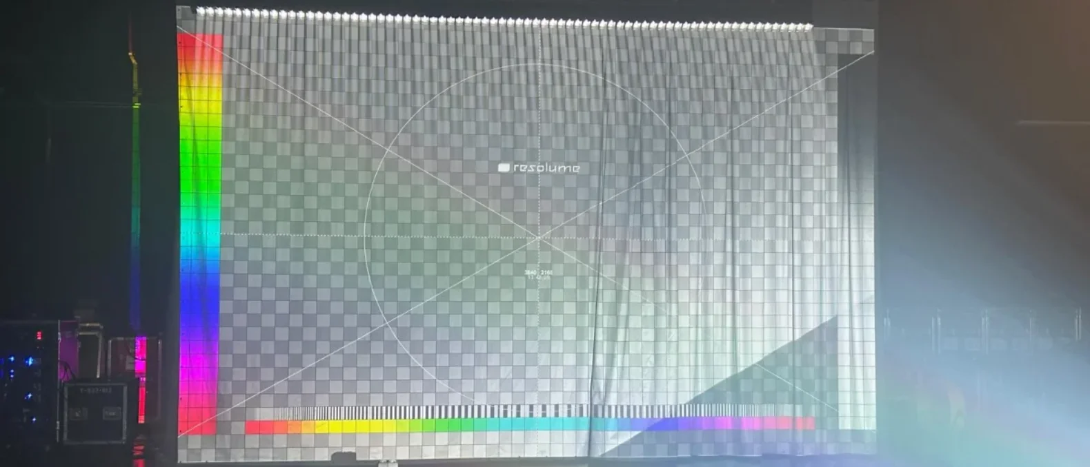 Two projectors mid-alignment, overlapping test grids and a soft blend band.