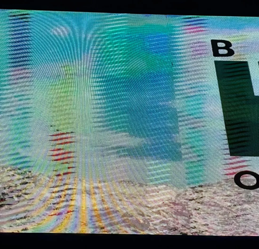 A direct-view LED wall photographed in focus: the emitter grid beats against the camera sensor into swirling colored interference bands across the whole picture.