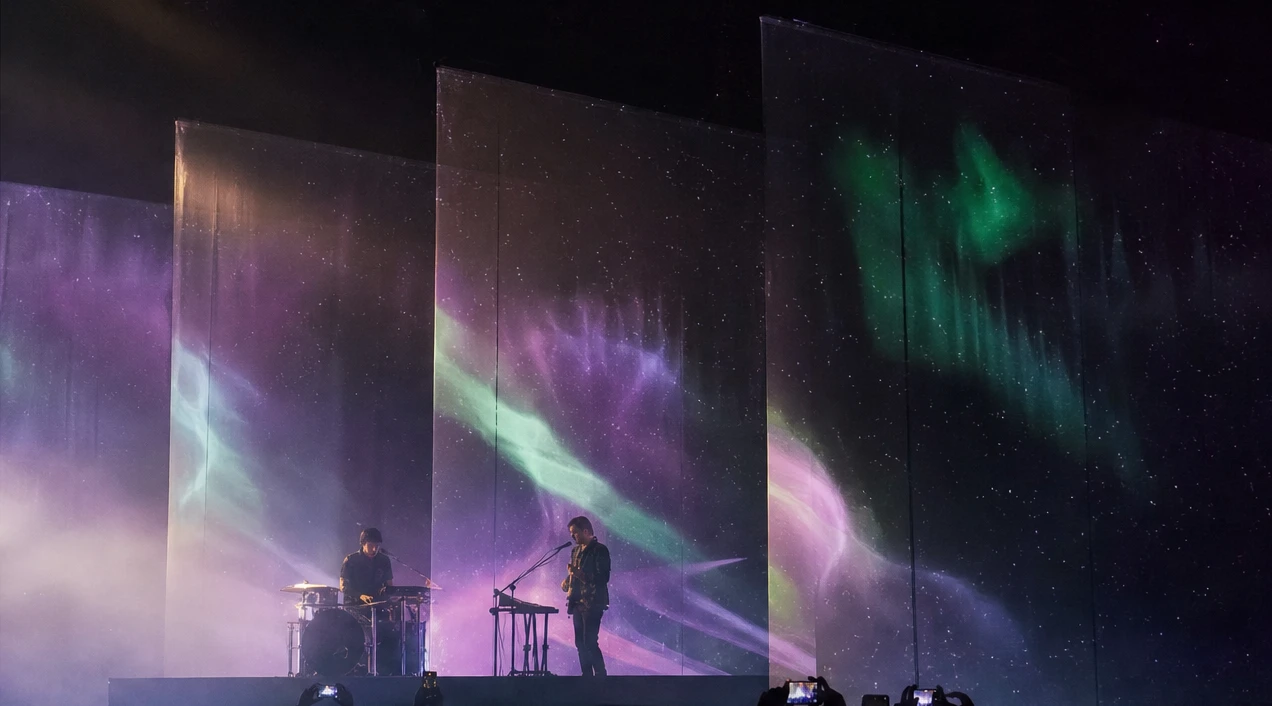 Violet aurora across the layered screens